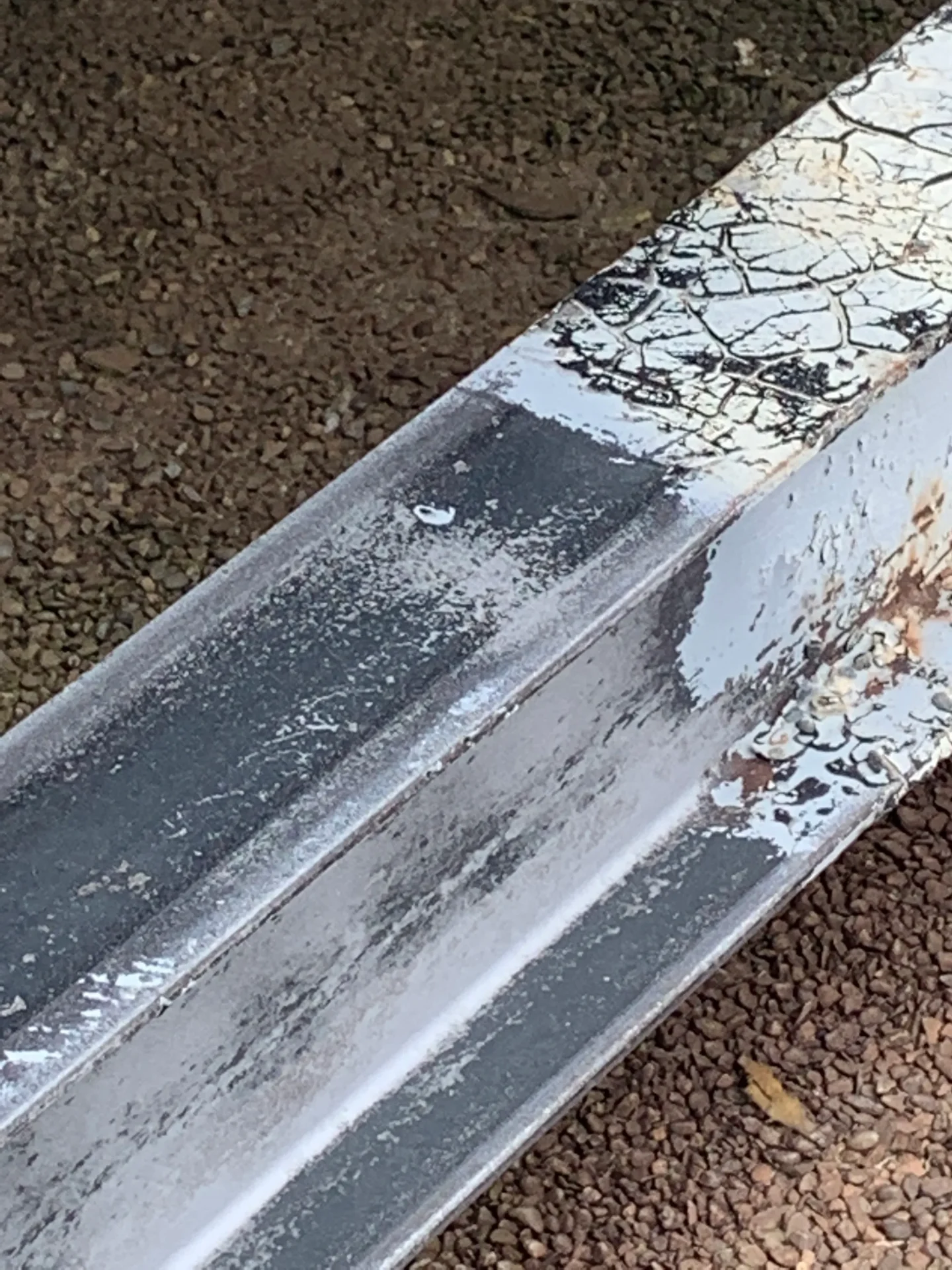 A metal rail with some paint on it