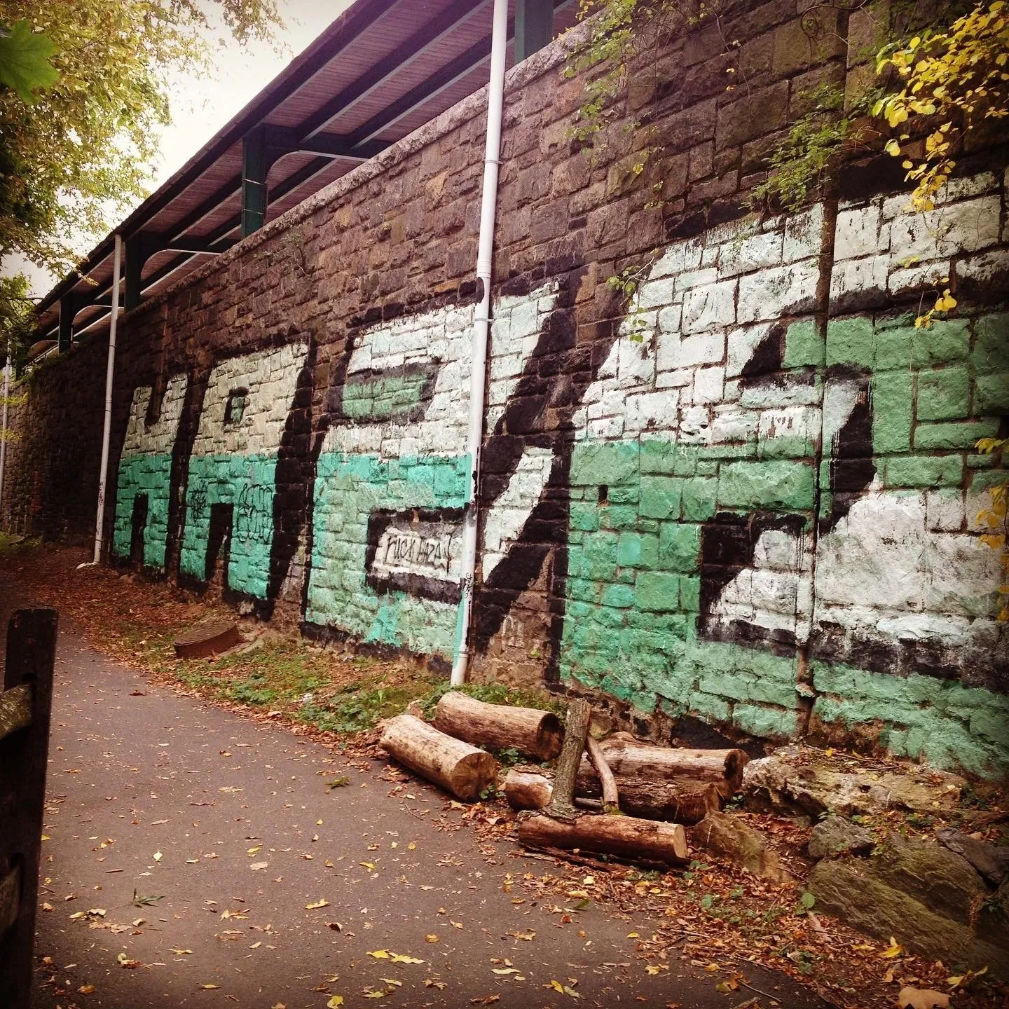 A brick wall with graffiti on it